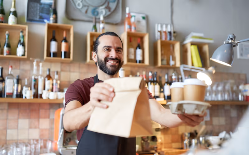 A cafe staff handing out take-away order